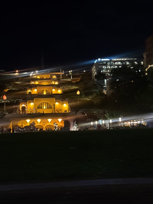 Yerevan's Cascade Complex glowing under golden lights at night