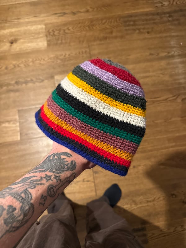 Person shows off striped beanie, takes mirror selfie in Hitchin