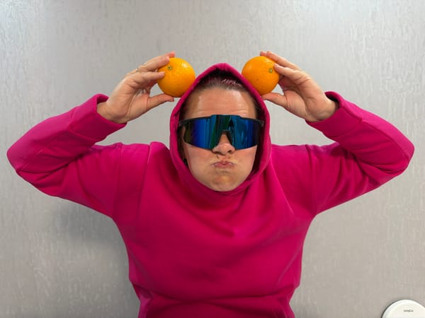 Person plays with oranges as ears in playful moment