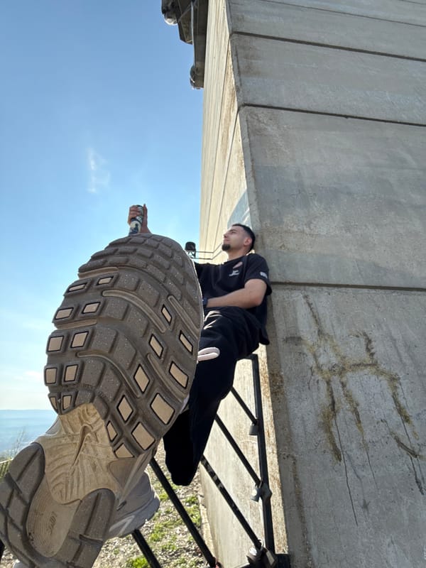 Person photographed resting on concrete ledge in Shumen