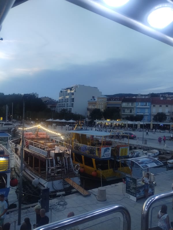 Crikvenica harbor at dusk, boats docked along the Adriatic