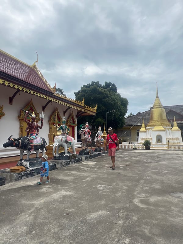 Ornate temple courtyard with statues, shrines, and religious iconography
