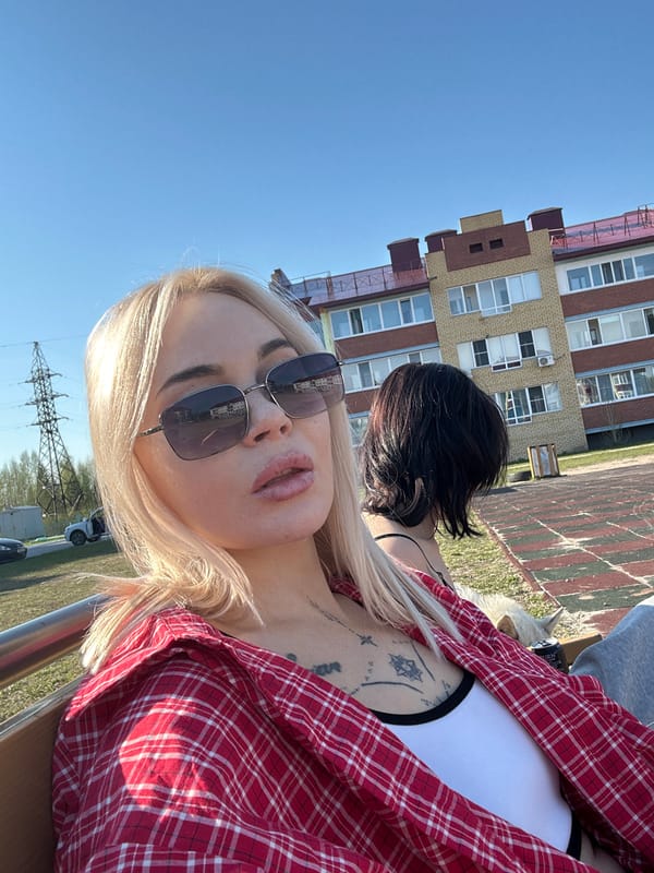 Woman and dog enjoy casual afternoon at Russian playground