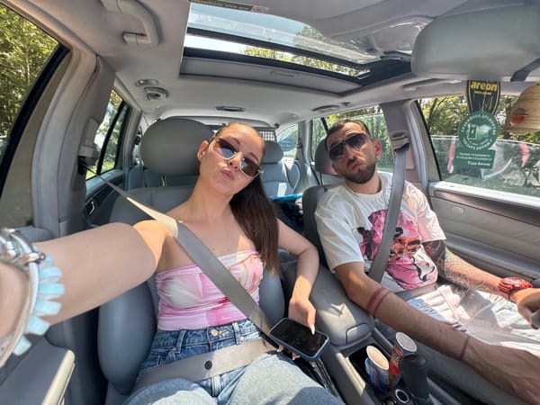 Two people take selfie in car in Primorsko, Bulgaria