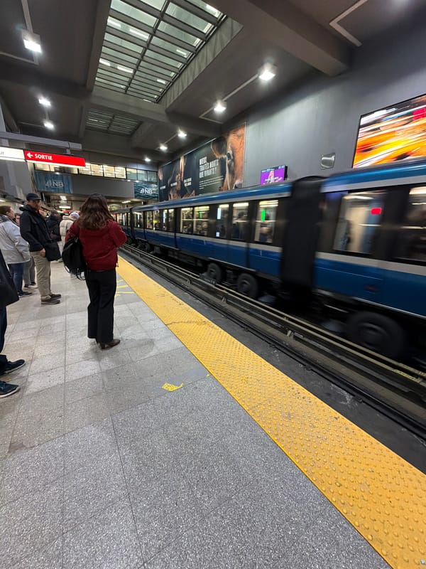 Blue metro train in motion at Montreal subway platform