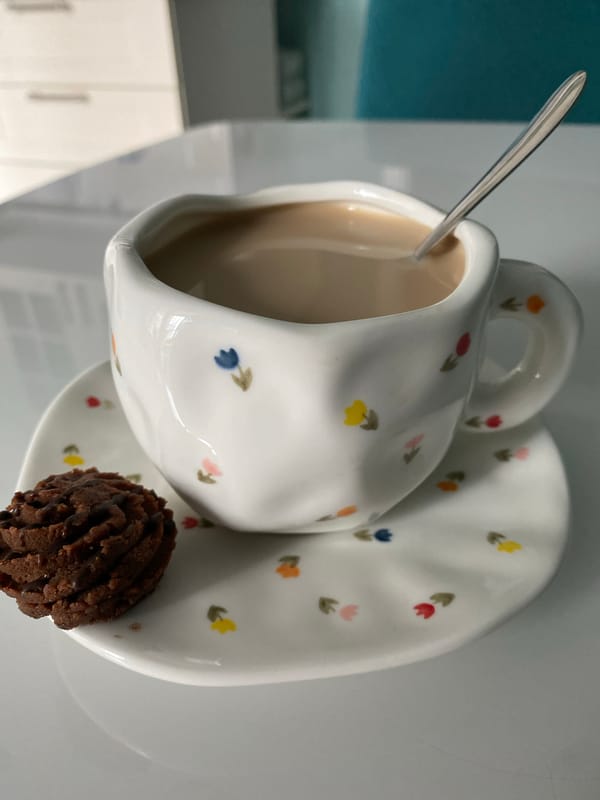 Studio tea cup photograph captured with chocolate cookie detail