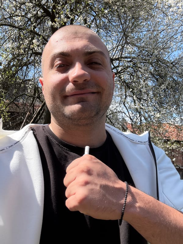 Man photographs spring blooms during village walk in Bulgaria