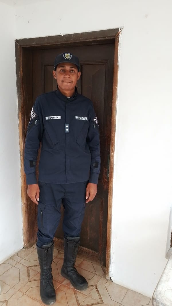 Uniformed young man poses for photo in Tinaquillo doorway