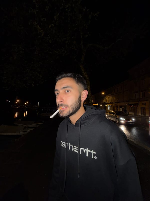 Person smoking cigarette at night in Rijeka, Croatia