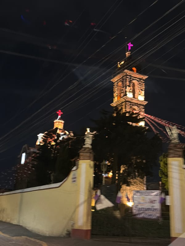 Historic illuminated churches photographed at night in Cholula