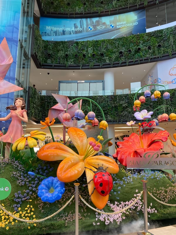 Decorative displays featuring flowers and adorned lion statues observed in Bangkok
