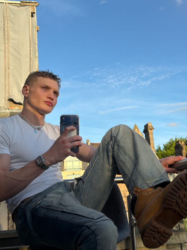 Young man takes selfies against London wall Friday evening