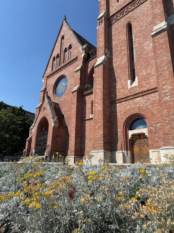 Gothic Revival red brick church in Budapest, clear summer day