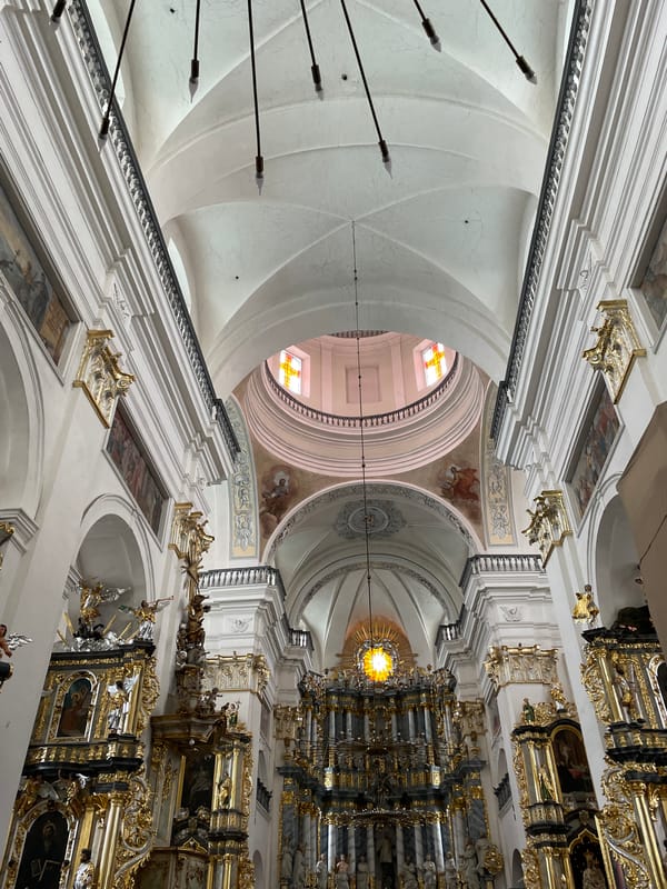 Visitor documents ornate Baroque church interior and exterior in Hrodna