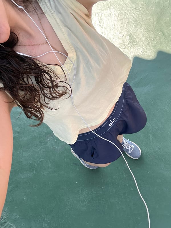 Tennis player and curious cat share outdoor court moment