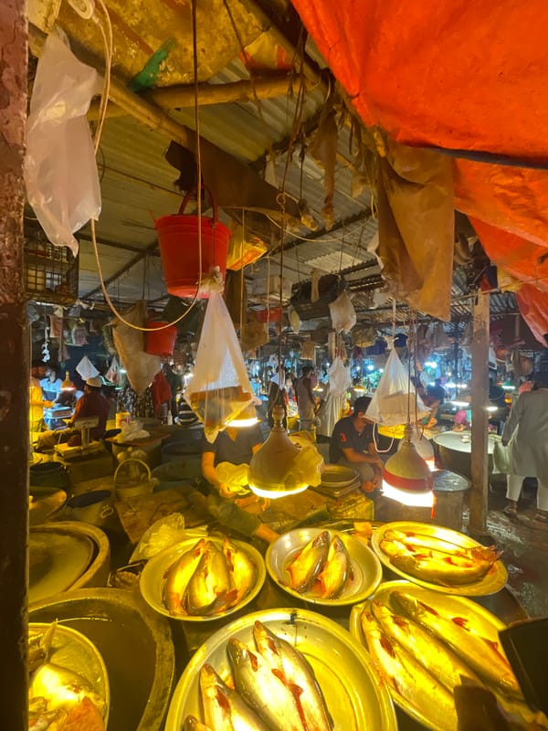 Night market bustles with vendors in Dhaka, Bangladesh