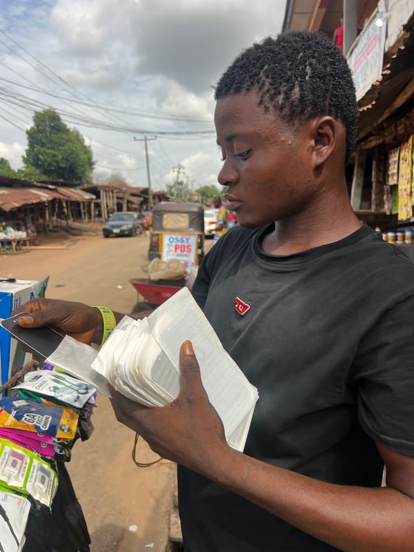 Street vendor sells phone accessories in urban marketplace