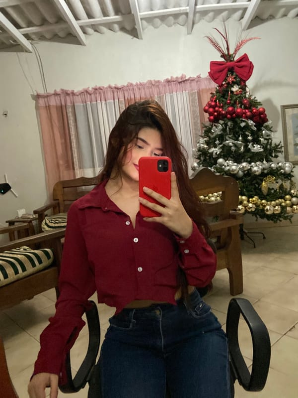 Woman takes selfies near Christmas tree in Juan Griego