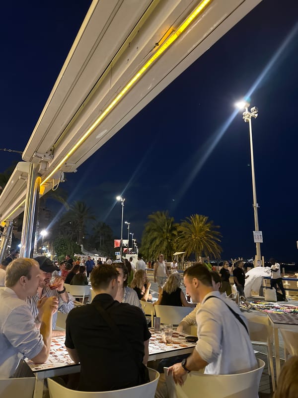Diners enjoy tropical themed waterfront restaurant with octopus sculpture