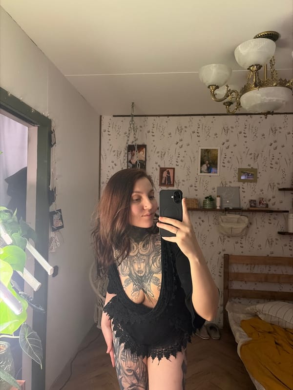 Woman takes mirror selfies in Chaikovsky showing extensive tattoos