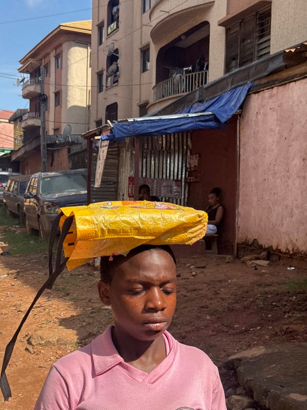 Everyday street life on a dusty Onitsha road