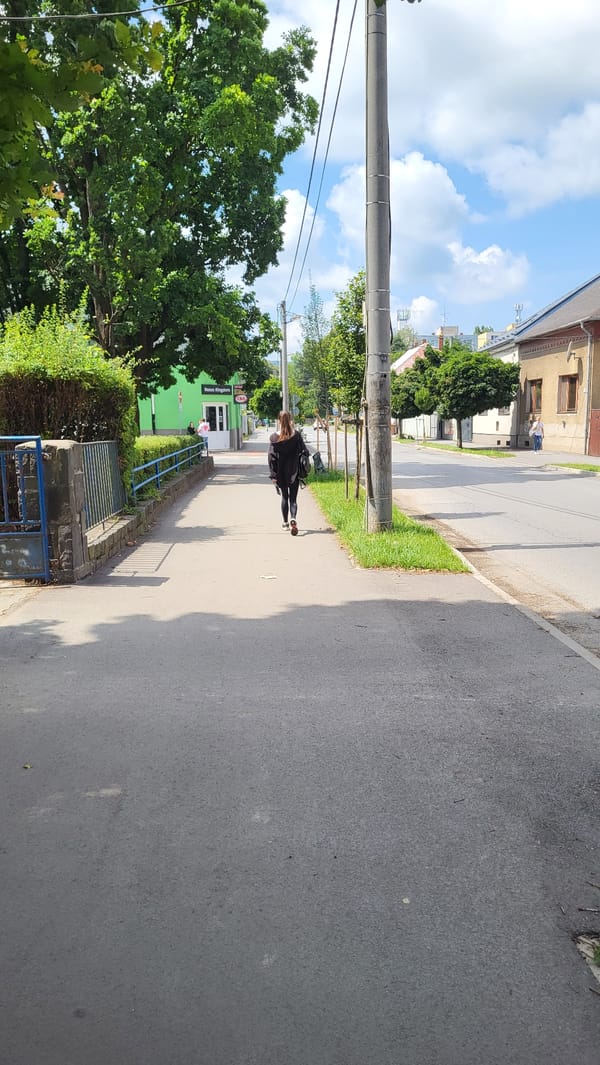 Morning foot traffic and a delivery rider on Prešov sidewalks