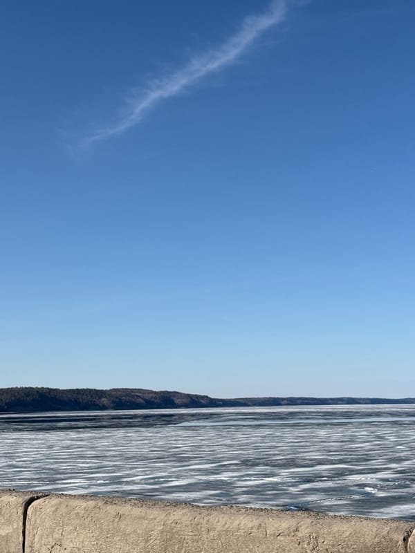 Woman explores waterfront areas in Chaikovsky, Russia during spring morning