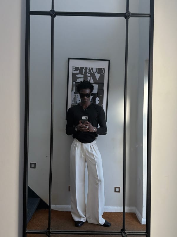 Person takes mirror selfies with artwork backdrop in London
