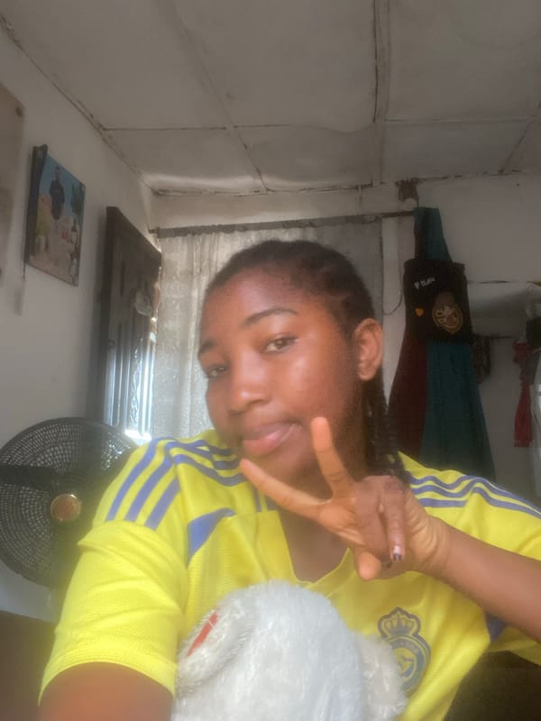 Woman poses with bandaged arm in Lokoja athletic wear