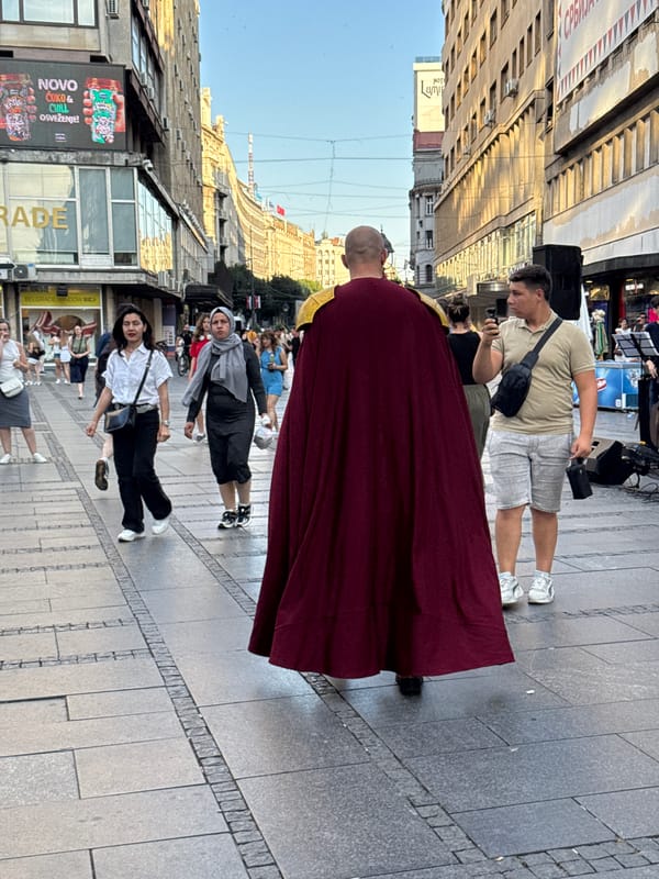 Robed figure strolling through Belgrade streets in summer