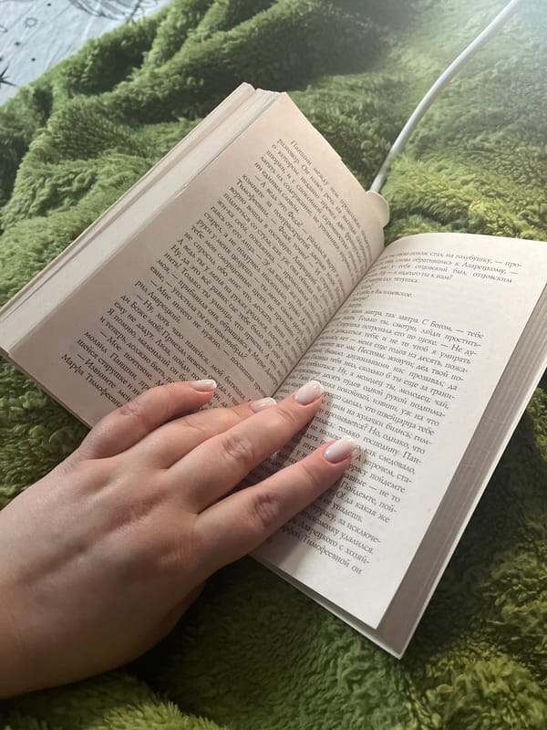 Woman reads Russian book indoors in Usman