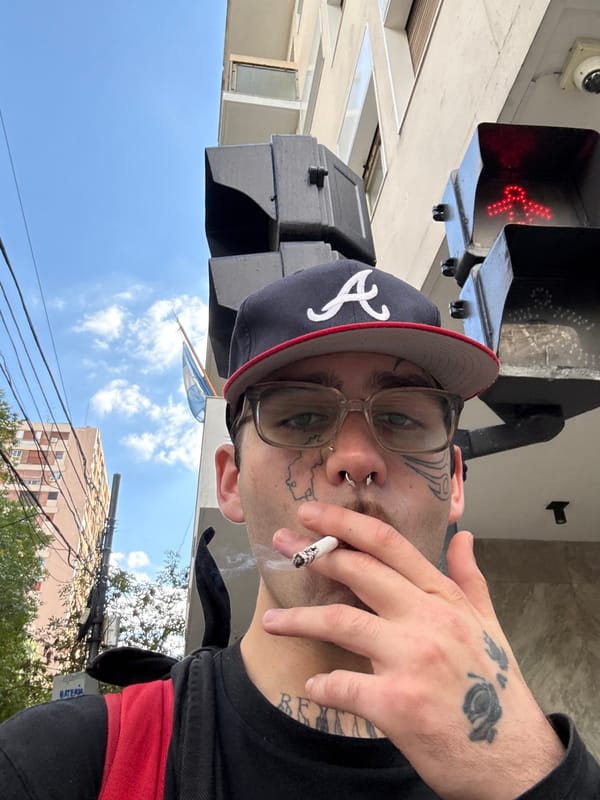 Tattooed individual spotted smoking in Buenos Aires street scene