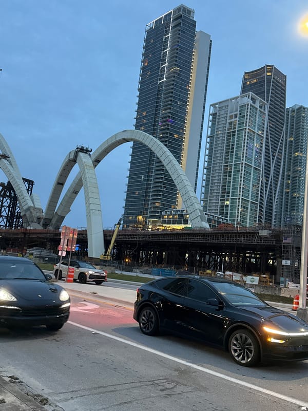 Miami bridge construction underway, arched concrete supports rising