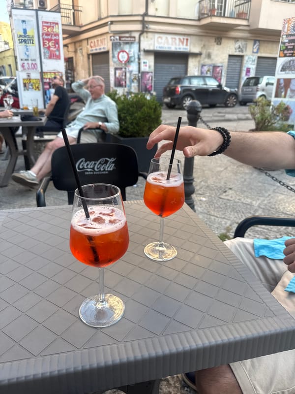 Couple enjoys Aperol Spritz at outdoor café in Palermo