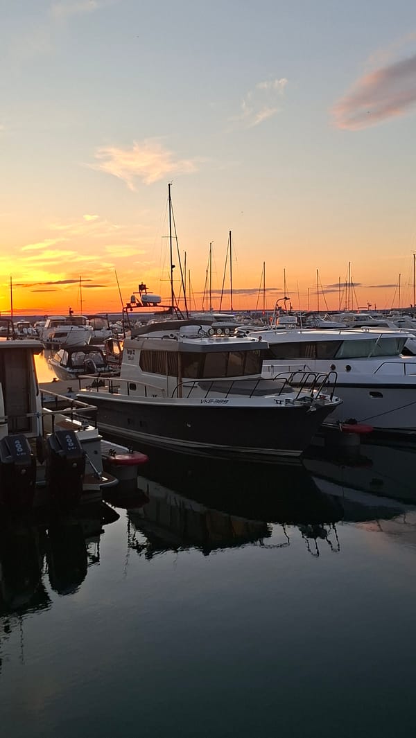 Sunset over Tallinn's marina, boats and golden light.