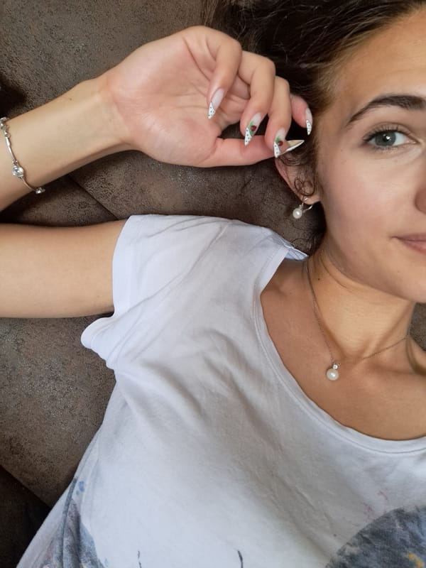 Woman in white shirt and pearls documented resting