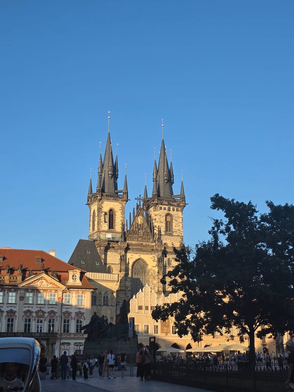 Tourist captures Prague Old Town scenes during golden hour
