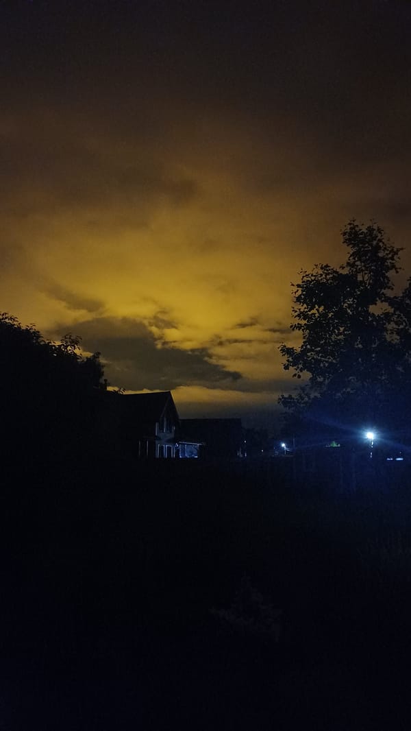 Yellow-orange sky phenomenon observed over Timokhovo, Russia nighttime