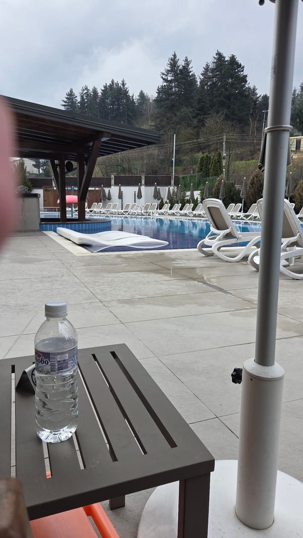 Pool area with lounge chairs observed in Bania, Bulgaria