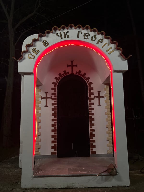 Religious monument glows with red lighting in Sungurlare, Bulgaria
