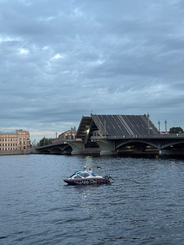 Evening on the Neva: drawbridges, a barge sculpture, Saint Petersburg skyline