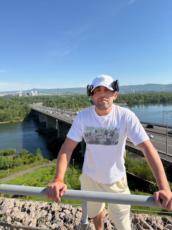Tourist photographed at Krasnoyarsk river overlook wearing LA shirt