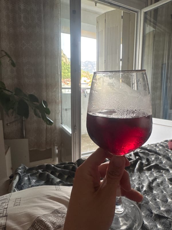 Chilled red wine in hand, Saint-Claude afternoon