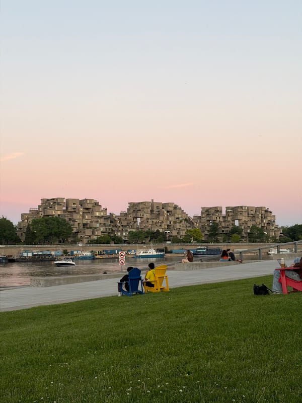 Evening waterfront gathering documented near Montreal's Habitat 67 complex