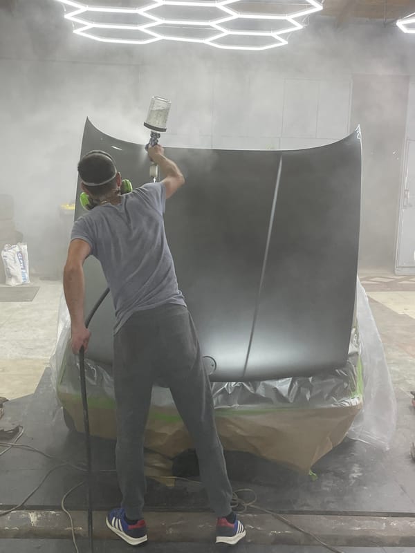 BMW E30 respray session in a garage workshop