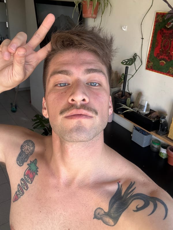 Tattooed man flashes peace sign in Cordoba