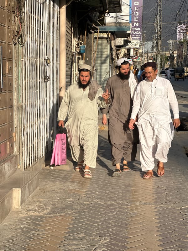 Street scene with multiple men documented in Quetta