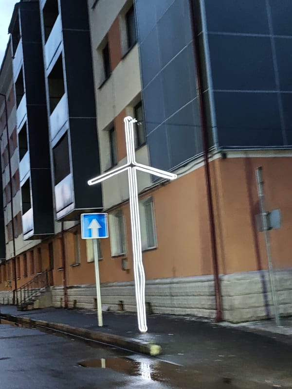 Wet streets and a glowing cross in Tqibuli, Georgia