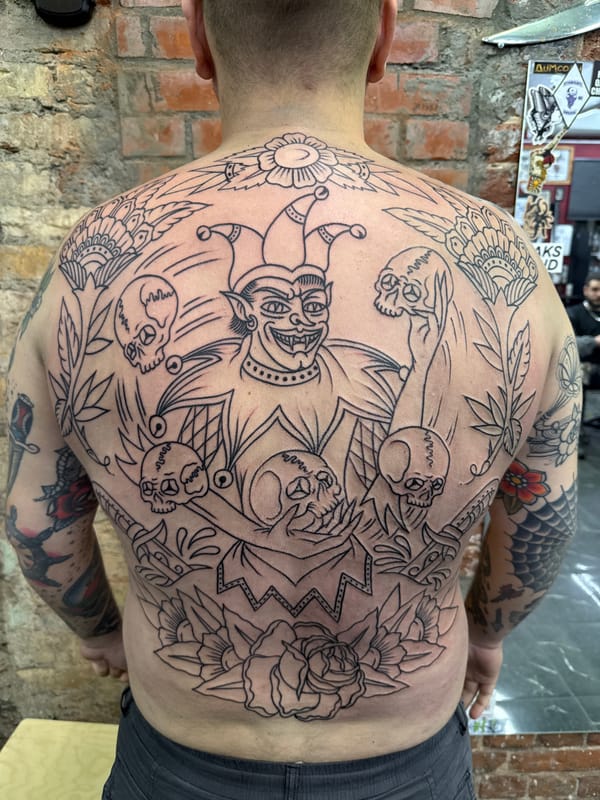 Elaborate tattoo artwork documented in Moscow featuring jester and skulls