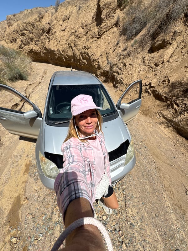 Woman explores Kyrgyzstan canyon terrain during early morning hike